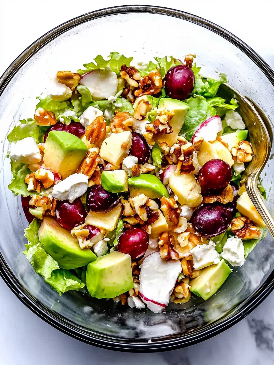 A bowl of salad with nuts and fruits.