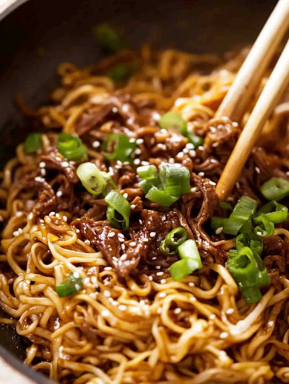 A bowl of noodles with meat and vegetables.