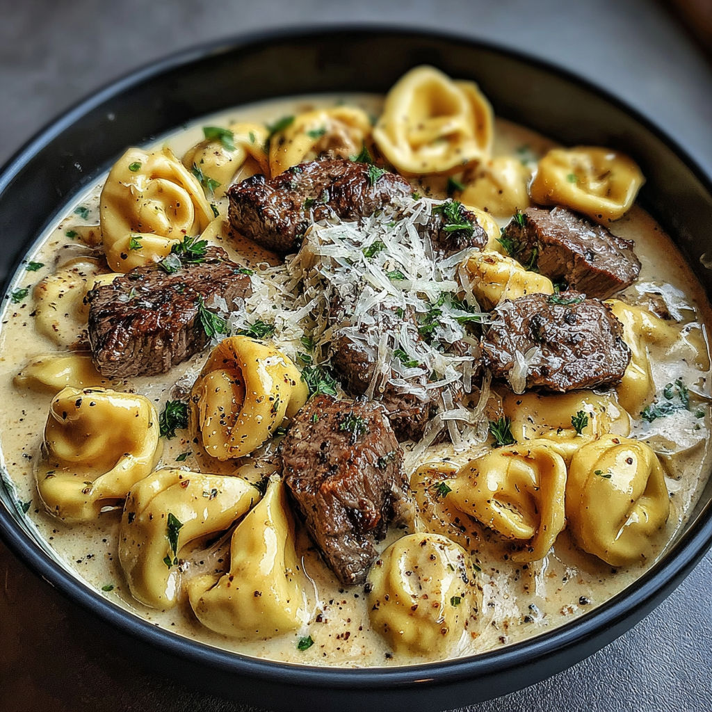 A bowl of food with meat and pasta.