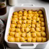 A white bowl filled with tater tots.
