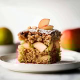 A slice of apple pie on a plate.