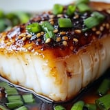 A piece of meat with sesame seeds on it.