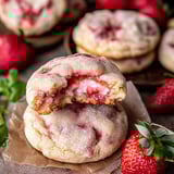 A cookie with strawberry jam and powdered sugar.