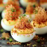 A plate of food with a sprig of parsley on top.