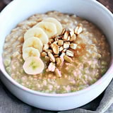 A bowl of oatmeal with bananas and nuts.