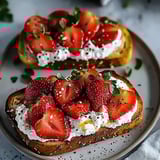 Two slices of bread with strawberries and whipped cream.