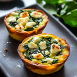 Two small green and white pies on a plate.