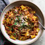 A bowl of pasta with meat sauce.