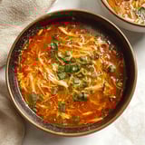 A bowl of soup with noodles and vegetables.