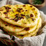 A basket of fluffy homemade naan.