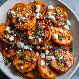 A plate of roasted sweet potatoes with feta cheese and honey.