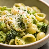 A bowl of pasta with broccoli and cheese.