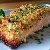 A piece of fish with a crispy parmesan crust.