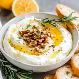 A bowl of spicy ricotta dip with hot honey.