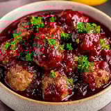 A bowl of meatballs in a red sauce.