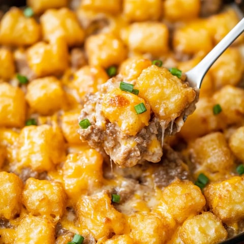 A spoon is in a bowl of food.