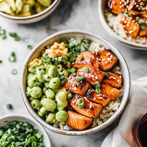 A bowl of rice with meat and vegetables.