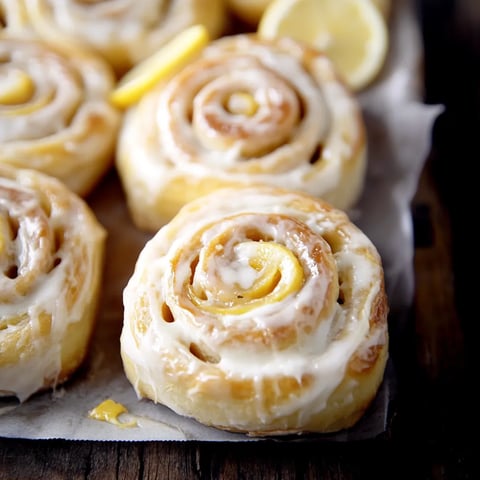 A plate of pastries with lemon and sugar.