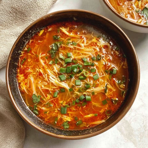 A bowl of soup with noodles and vegetables.