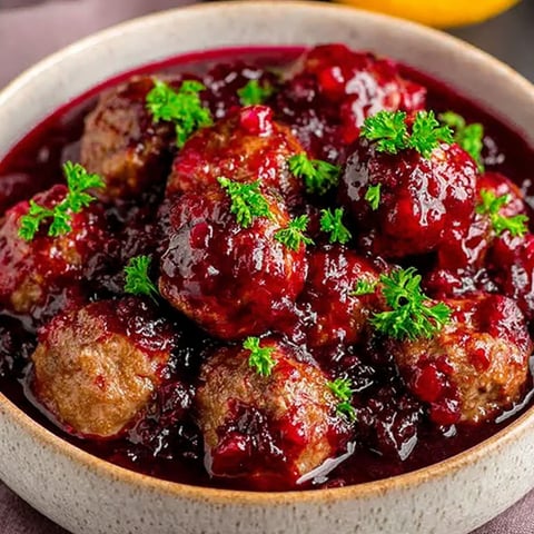 A bowl of meatballs in a red sauce.
